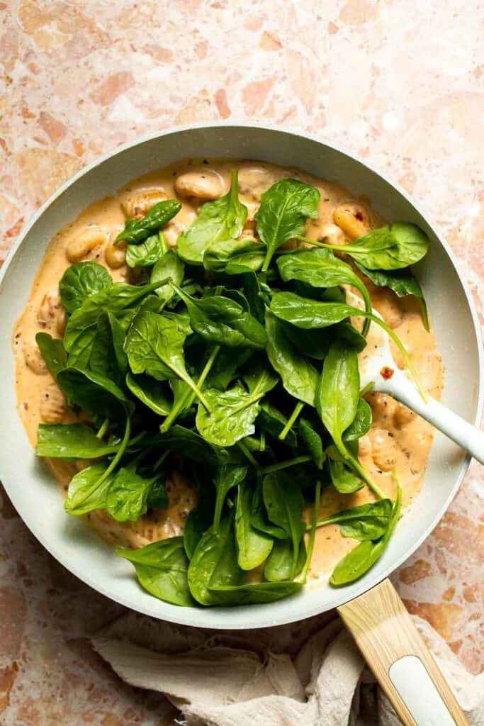 This creamy Tuscan gnocchi is a quick one pan dinner with sun dried tomatoes, spinach, garlic, and Parmesan. | aheadofthyme.com