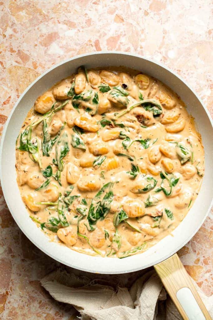 This creamy Tuscan gnocchi is a quick one pan dinner with sun dried tomatoes, spinach, garlic, and Parmesan. | aheadofthyme.com