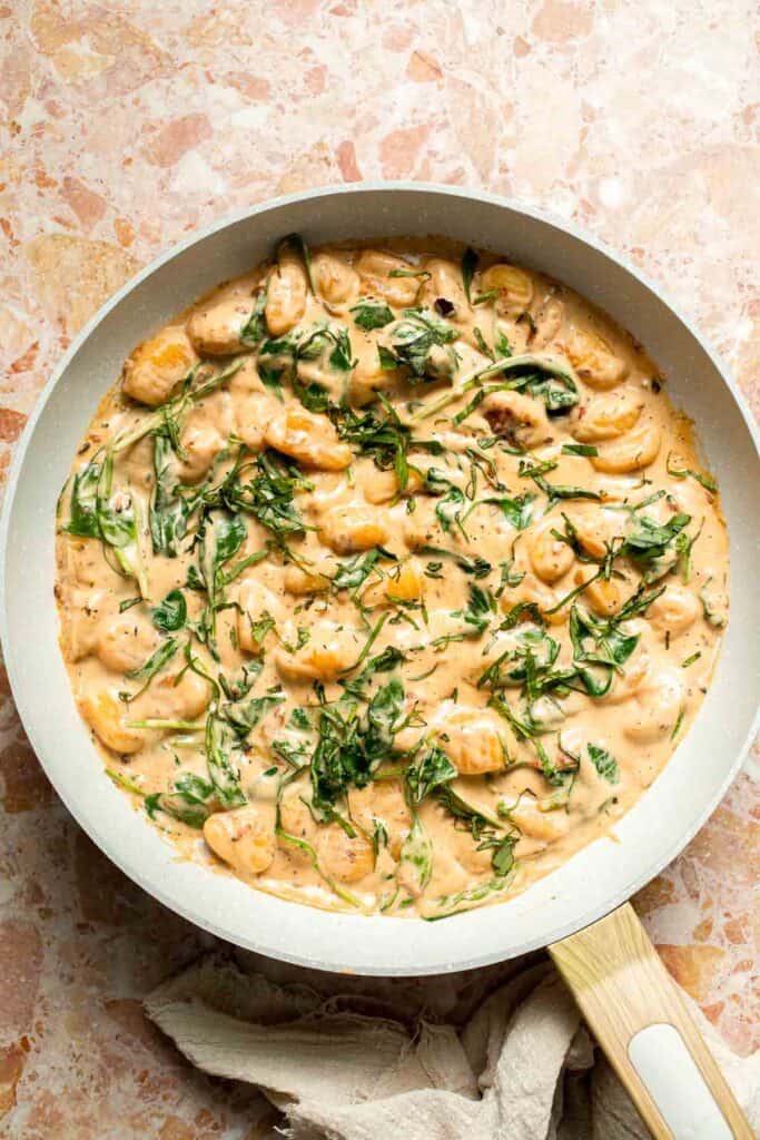 This creamy Tuscan gnocchi is a quick one pan dinner with sun dried tomatoes, spinach, garlic, and Parmesan. | aheadofthyme.com