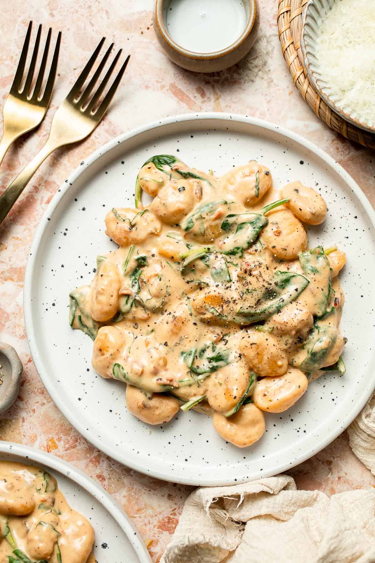 This creamy Tuscan gnocchi is a quick one pan dinner with sun dried tomatoes, spinach, garlic, and Parmesan. | aheadofthyme.com