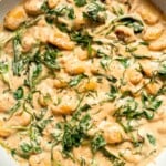 This creamy Tuscan gnocchi is a quick one pan dinner with sun dried tomatoes, spinach, garlic, and Parmesan. | aheadofthyme.com