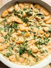 This creamy Tuscan gnocchi is a quick one pan dinner with sun dried tomatoes, spinach, garlic, and Parmesan. | aheadofthyme.com