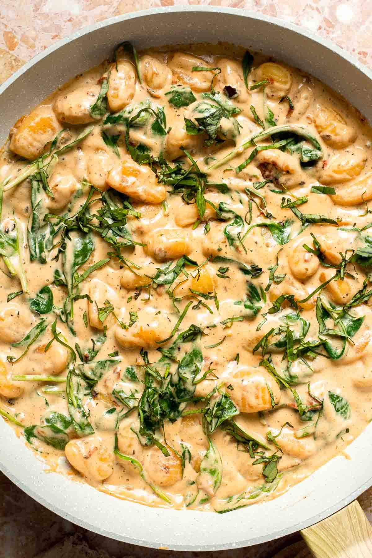 This creamy Tuscan gnocchi is a quick one pan dinner with sun dried tomatoes, spinach, garlic, and Parmesan. | aheadofthyme.com