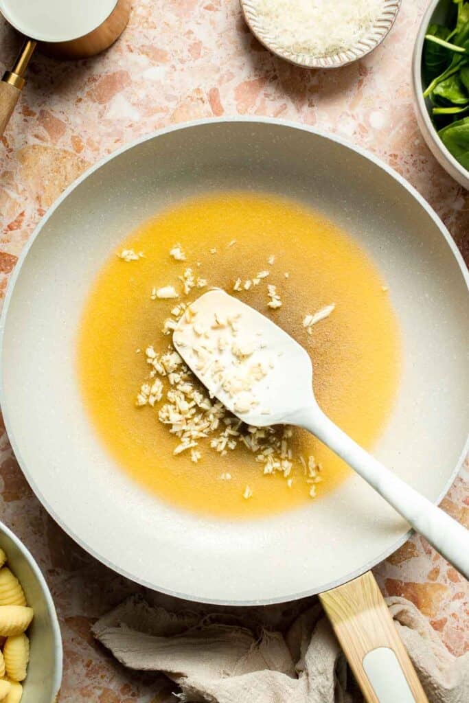 This creamy Tuscan gnocchi is a quick one pan dinner with sun dried tomatoes, spinach, garlic, and Parmesan. | aheadofthyme.com