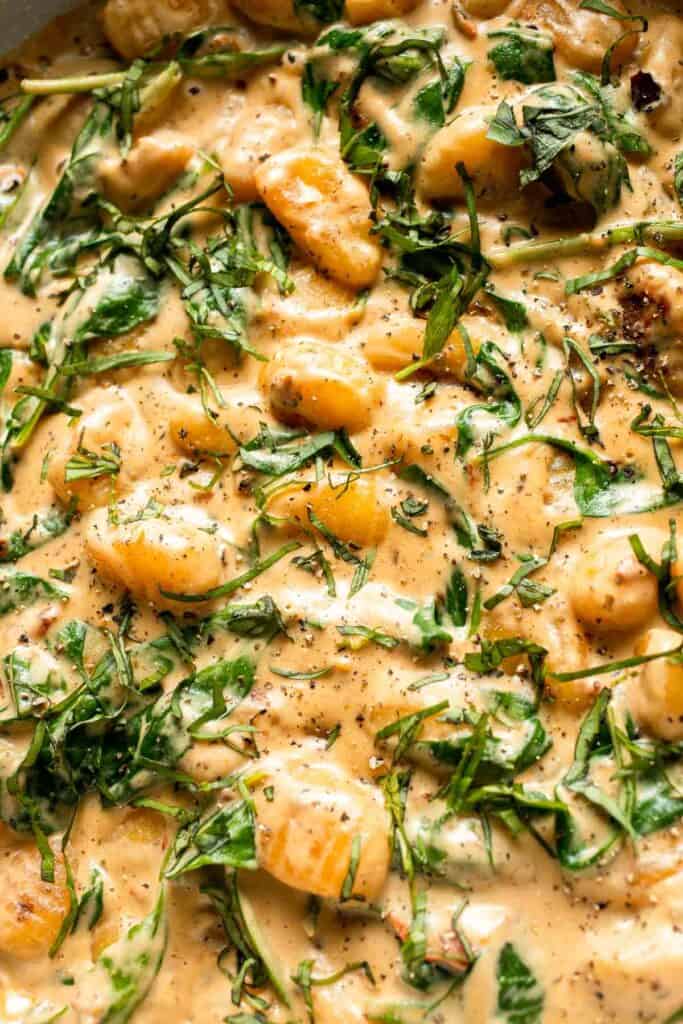 This creamy Tuscan gnocchi is a quick one pan dinner with sun dried tomatoes, spinach, garlic, and Parmesan. | aheadofthyme.com