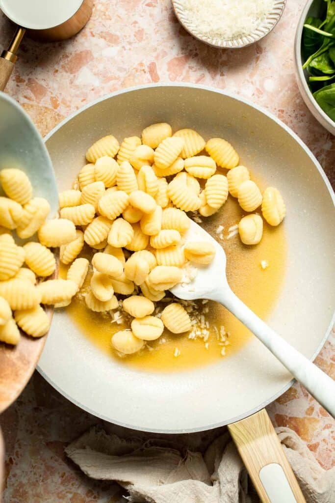 This creamy Tuscan gnocchi is a quick one pan dinner with sun dried tomatoes, spinach, garlic, and Parmesan. | aheadofthyme.com