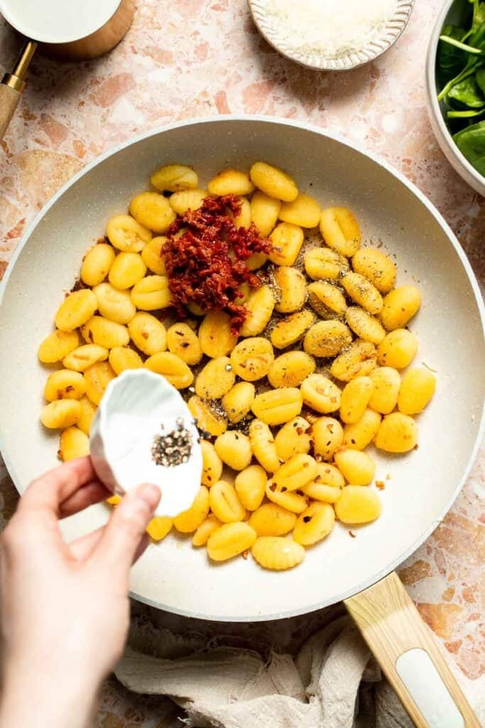 This creamy Tuscan gnocchi is a quick one pan dinner with sun dried tomatoes, spinach, garlic, and Parmesan. | aheadofthyme.com