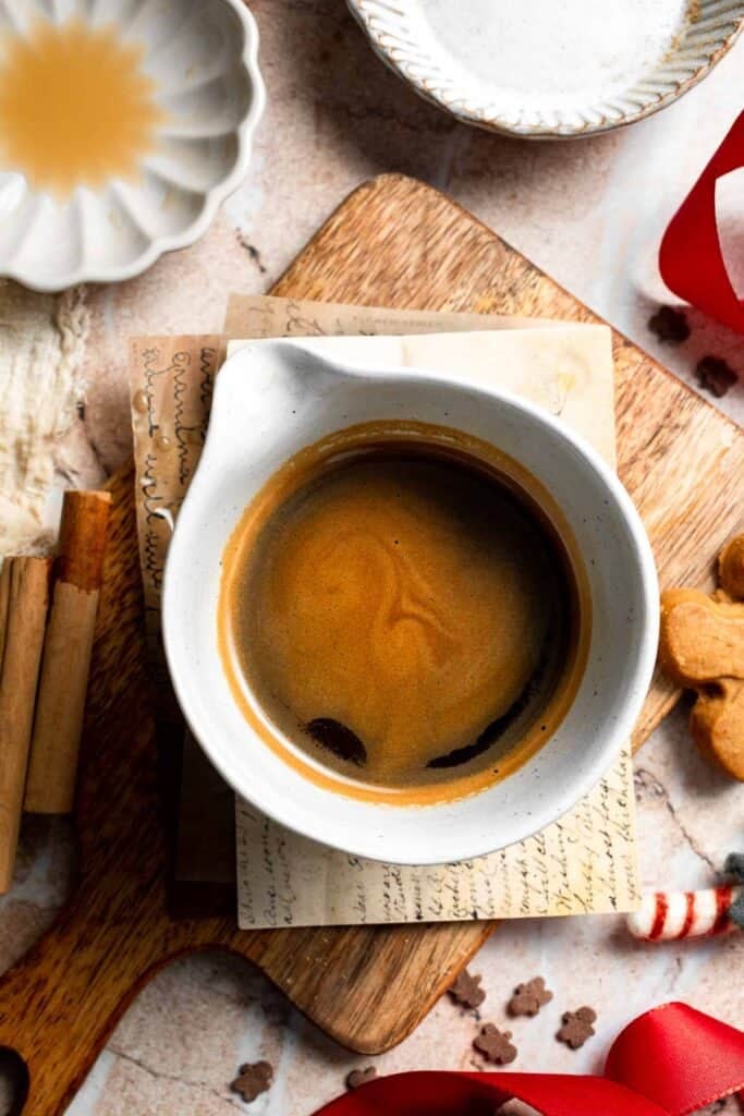 Cozy homemade gingerbread latte recipe made with homemade gingerbread syrup, espresso, warm spices, and steamed milk. | aheadofthyme.com