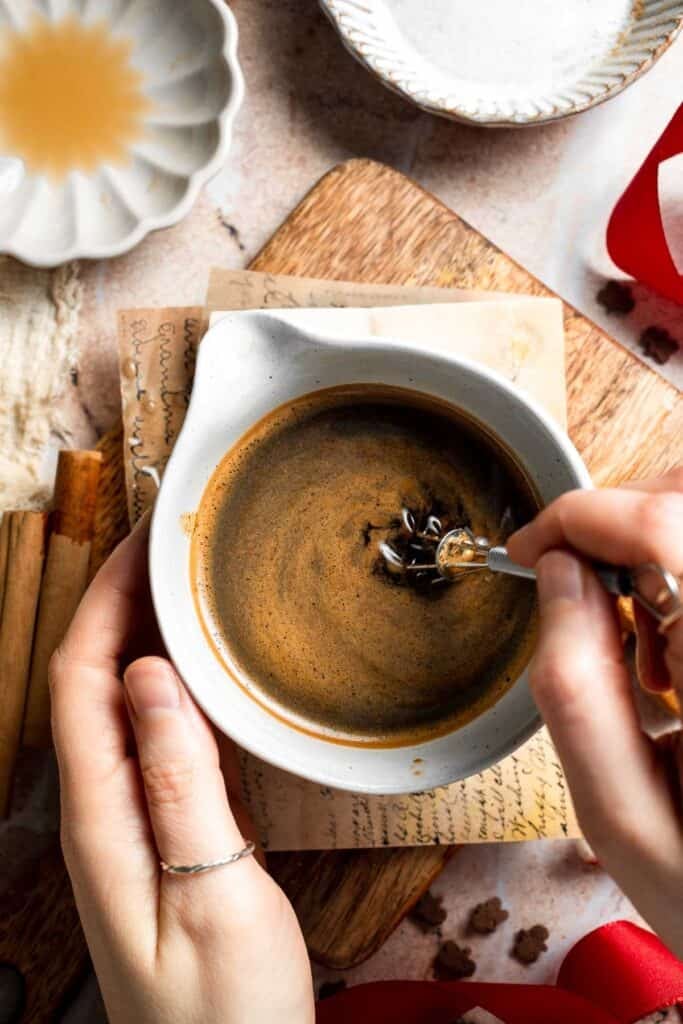 Cozy homemade gingerbread latte recipe made with homemade gingerbread syrup, espresso, warm spices, and steamed milk. | aheadofthyme.com