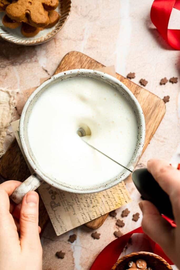 Cozy homemade gingerbread latte recipe made with homemade gingerbread syrup, espresso, warm spices, and steamed milk. | aheadofthyme.com