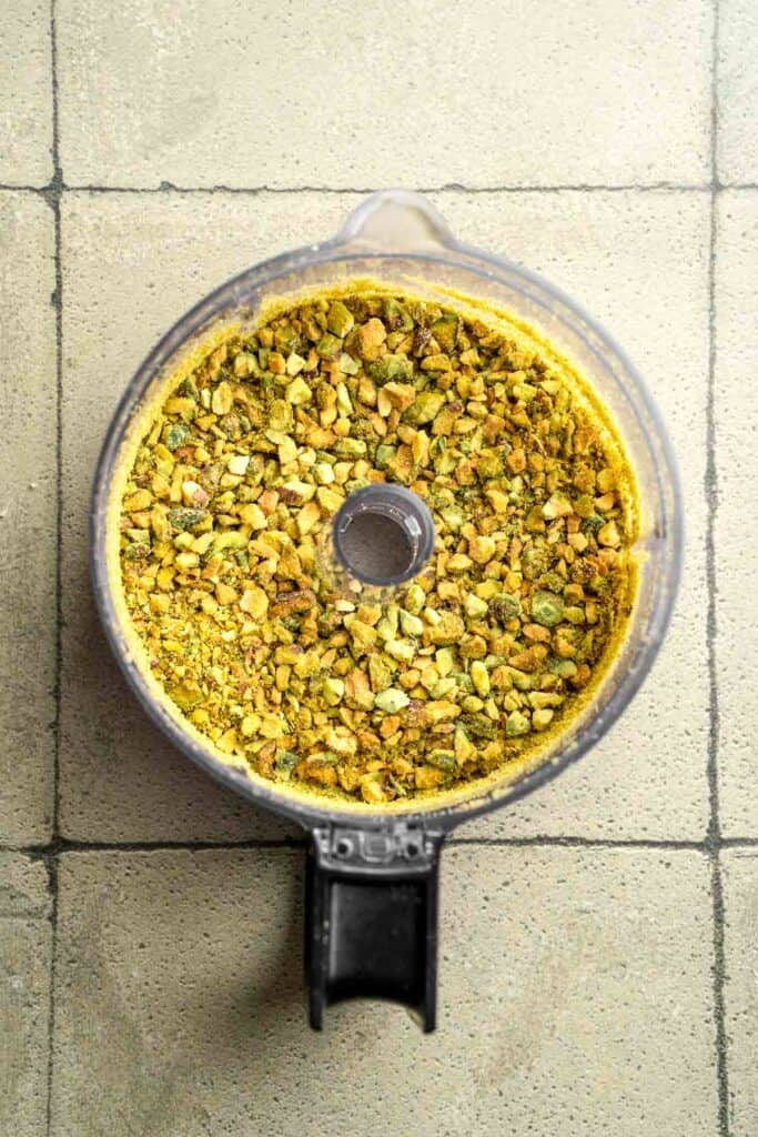 Buttery pistachio thumbprint cookies filled with pistachio white chocolate ganache that bake into elegant, nutty treats perfect for gifting or any occasion. | aheadofthyme.com