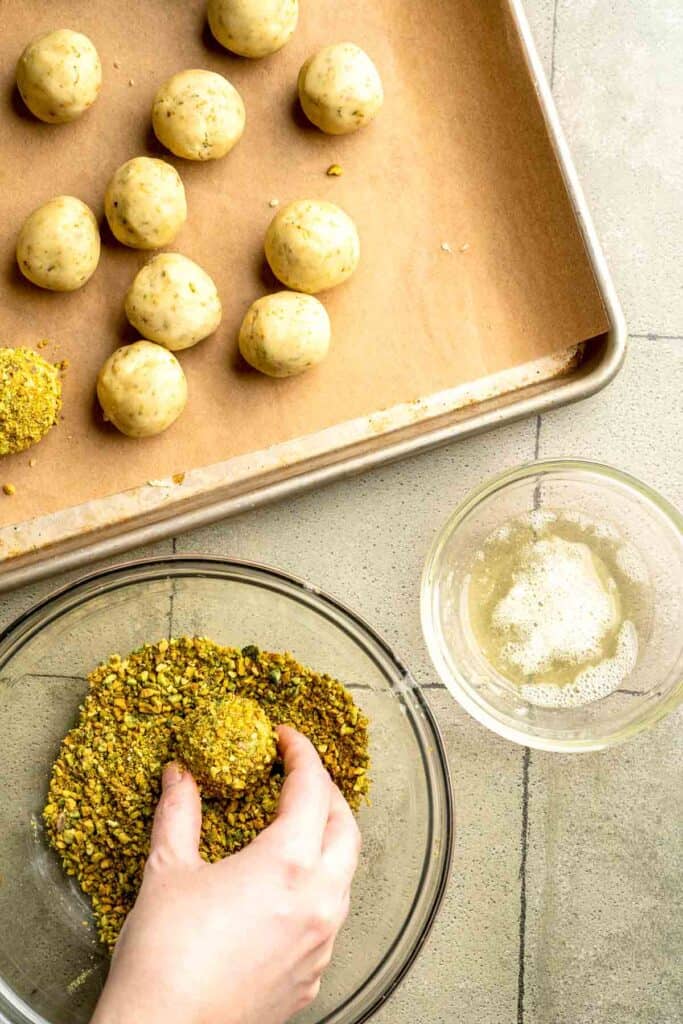 Buttery pistachio thumbprint cookies filled with pistachio white chocolate ganache that bake into elegant, nutty treats perfect for gifting or any occasion. | aheadofthyme.com