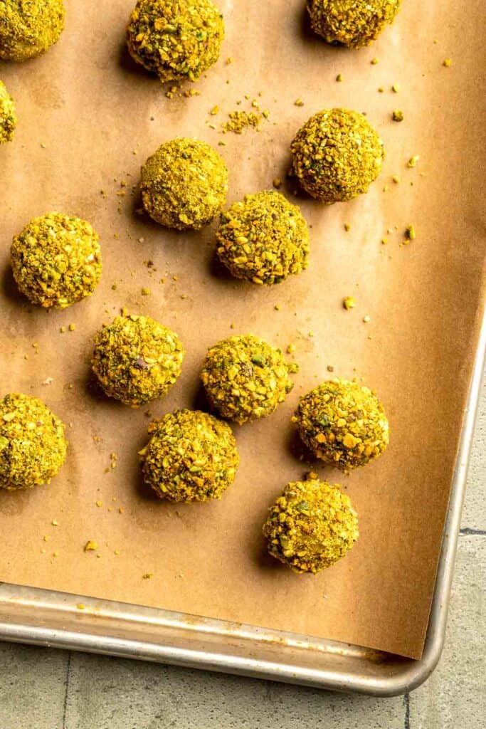 Buttery pistachio thumbprint cookies filled with pistachio white chocolate ganache that bake into elegant, nutty treats perfect for gifting or any occasion. | aheadofthyme.com