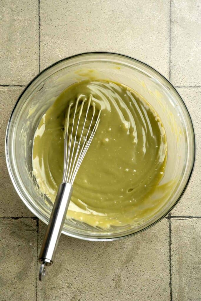 Buttery pistachio thumbprint cookies filled with pistachio white chocolate ganache that bake into elegant, nutty treats perfect for gifting or any occasion. | aheadofthyme.com