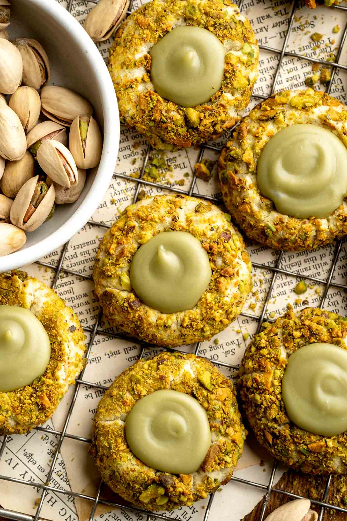 Buttery pistachio thumbprint cookies filled with pistachio white chocolate ganache that bake into elegant, nutty treats perfect for gifting or any occasion. | aheadofthyme.com