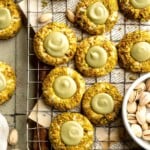 Buttery pistachio thumbprint cookies filled with pistachio white chocolate ganache that bake into elegant, nutty treats perfect for gifting or any occasion. | aheadofthyme.com