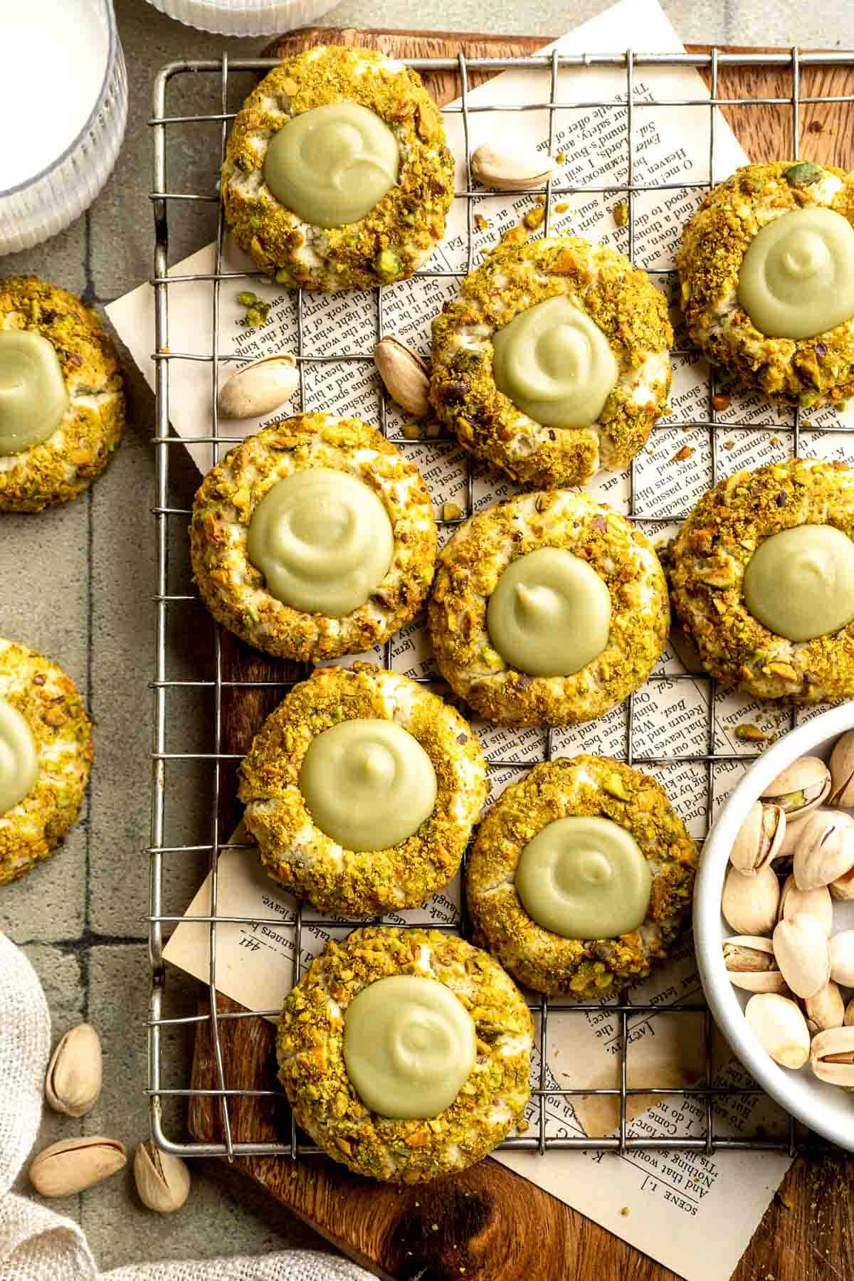 Buttery pistachio thumbprint cookies filled with pistachio white chocolate ganache that bake into elegant, nutty treats perfect for gifting or any occasion. | aheadofthyme.com