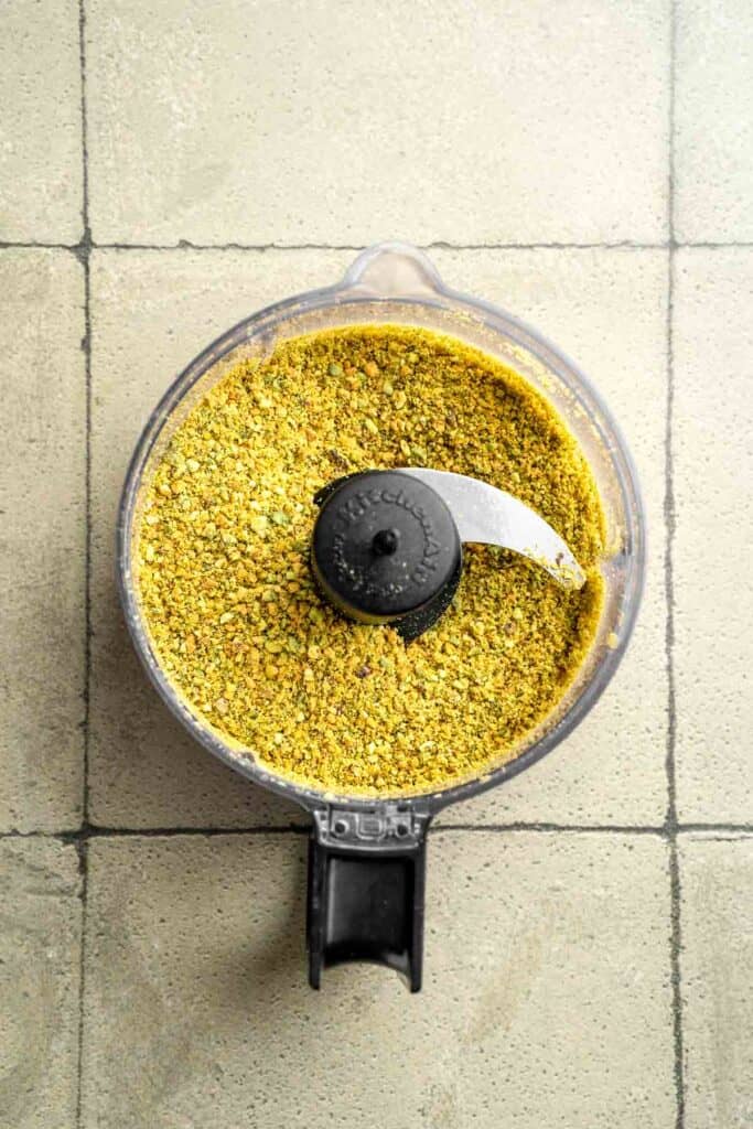 Buttery pistachio thumbprint cookies filled with pistachio white chocolate ganache that bake into elegant, nutty treats perfect for gifting or any occasion. | aheadofthyme.com