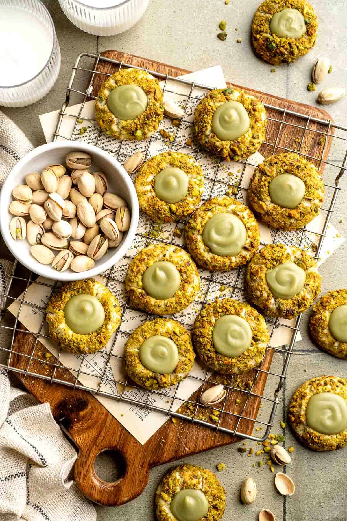 Buttery pistachio thumbprint cookies filled with pistachio white chocolate ganache that bake into elegant, nutty treats perfect for gifting or any occasion. | aheadofthyme.com