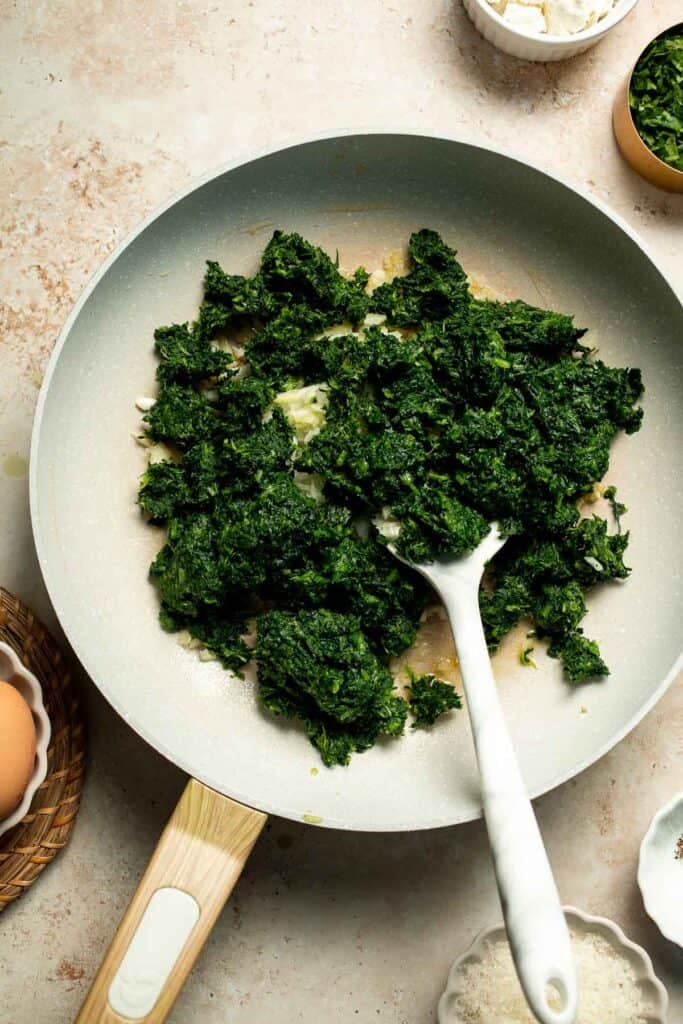 Flaky spinach puff pastry bites filled with sautéed spinach, feta, and parmesan. An easy, crowd pleasing appetizer for any occasion. | aheadofthyme.com