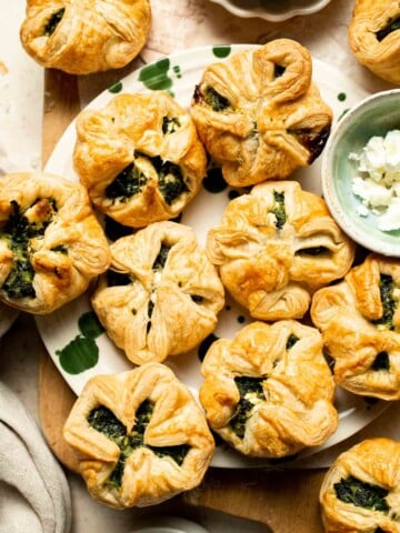 Flaky spinach puff pastry bites filled with sautéed spinach, feta, and parmesan. An easy, crowd pleasing appetizer for any occasion. | aheadofthyme.com