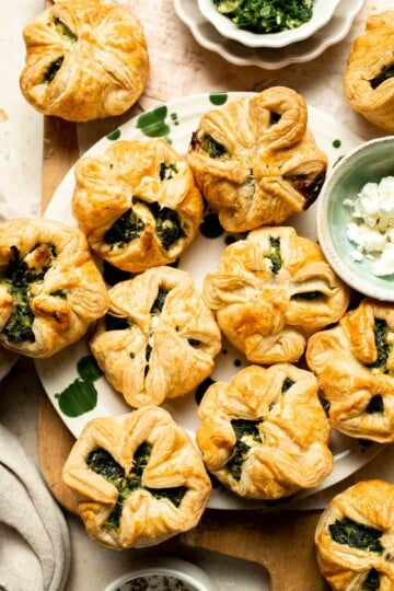 Flaky spinach puff pastry bites filled with sautéed spinach, feta, and parmesan. An easy, crowd pleasing appetizer for any occasion. | aheadofthyme.com