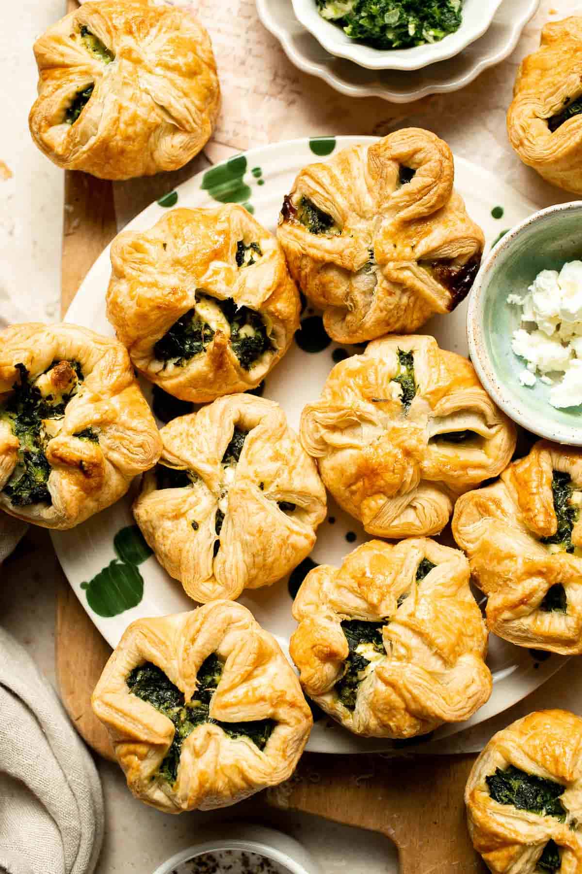 Flaky spinach puff pastry bites filled with sautéed spinach, feta, and parmesan. An easy, crowd pleasing appetizer for any occasion. | aheadofthyme.com