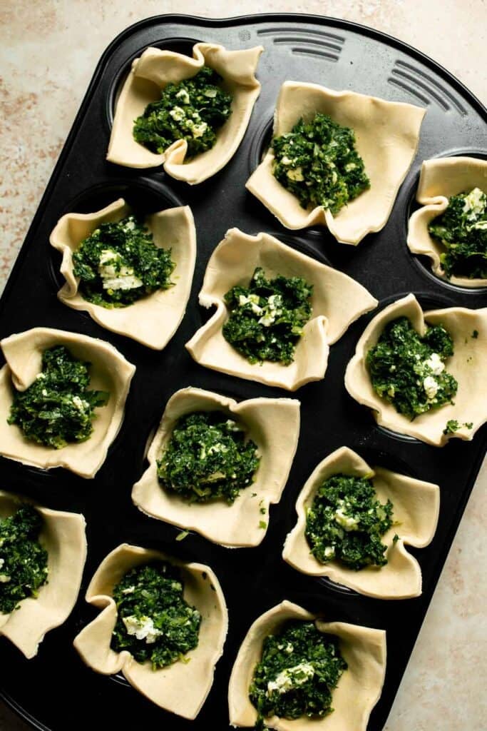 Flaky spinach puff pastry bites filled with sautéed spinach, feta, and parmesan. An easy, crowd pleasing appetizer for any occasion. | aheadofthyme.com
