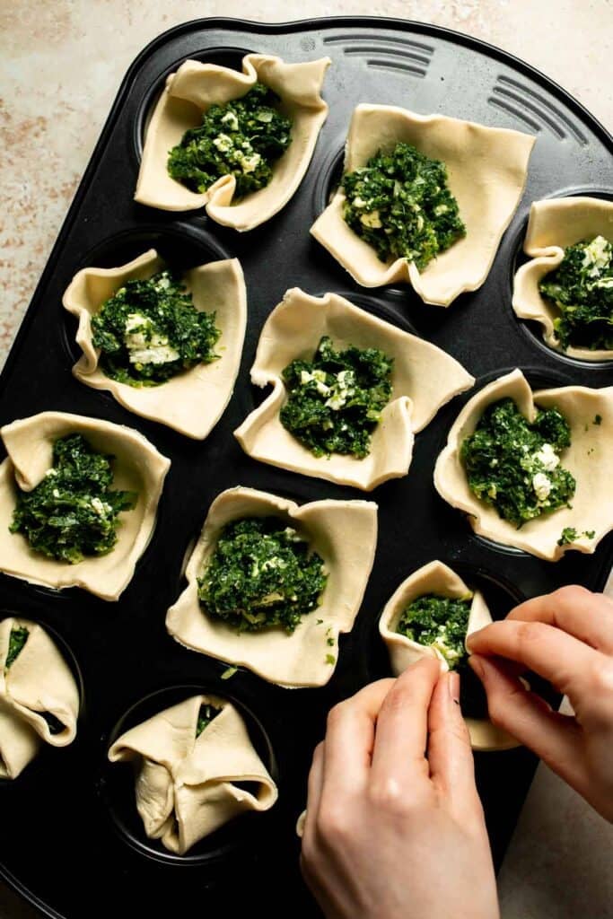 Flaky spinach puff pastry bites filled with sautéed spinach, feta, and parmesan. An easy, crowd pleasing appetizer for any occasion. | aheadofthyme.com