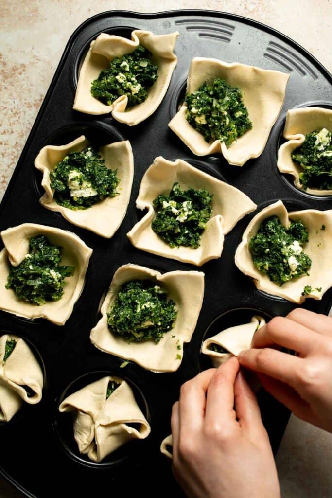 Flaky spinach puff pastry bites filled with sautéed spinach, feta, and parmesan. An easy, crowd pleasing appetizer for any occasion. | aheadofthyme.com