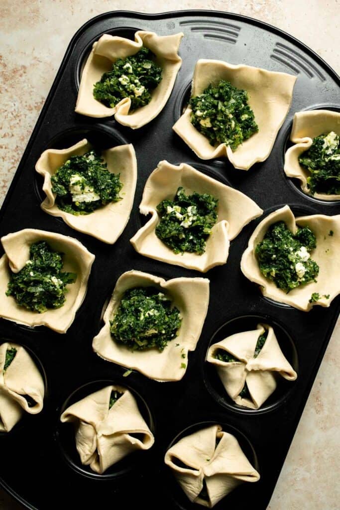 Flaky spinach puff pastry bites filled with sautéed spinach, feta, and parmesan. An easy, crowd pleasing appetizer for any occasion. | aheadofthyme.com