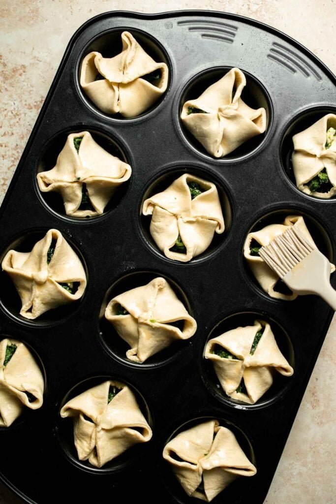Flaky spinach puff pastry bites filled with sautéed spinach, feta, and parmesan. An easy, crowd pleasing appetizer for any occasion. | aheadofthyme.com