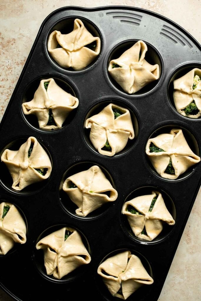 Flaky spinach puff pastry bites filled with sautéed spinach, feta, and parmesan. An easy, crowd pleasing appetizer for any occasion. | aheadofthyme.com