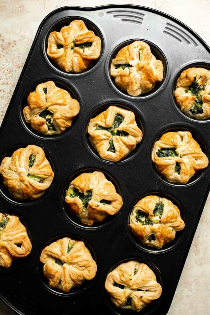 Flaky spinach puff pastry bites filled with sautéed spinach, feta, and parmesan. An easy, crowd pleasing appetizer for any occasion. | aheadofthyme.com