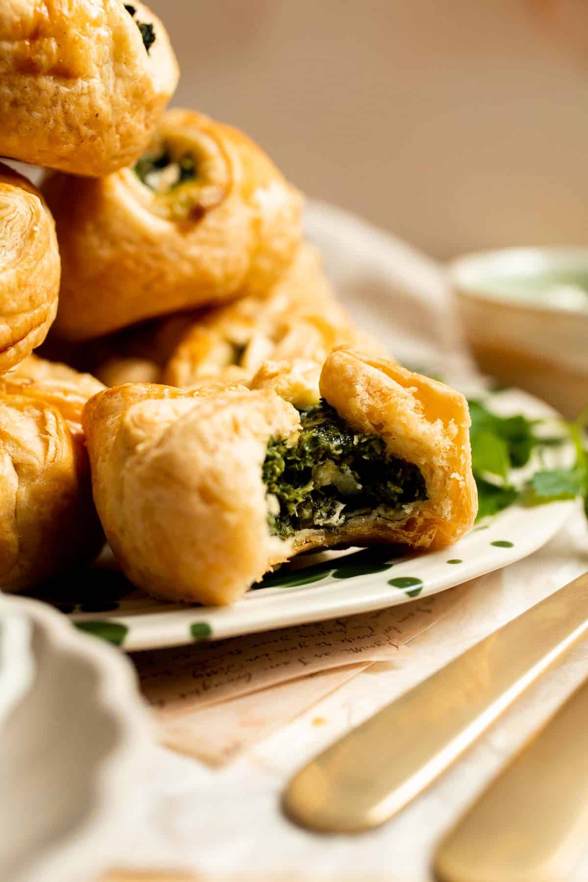Flaky spinach puff pastry bites filled with sautéed spinach, feta, and parmesan. An easy, crowd pleasing appetizer for any occasion. | aheadofthyme.com