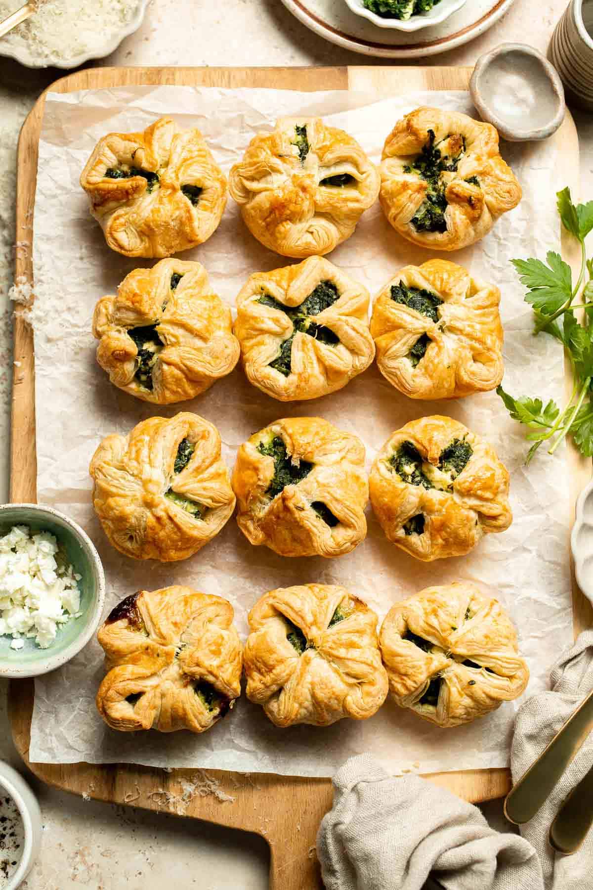 Flaky spinach puff pastry bites filled with sautéed spinach, feta, and parmesan. An easy, crowd pleasing appetizer for any occasion. | aheadofthyme.com