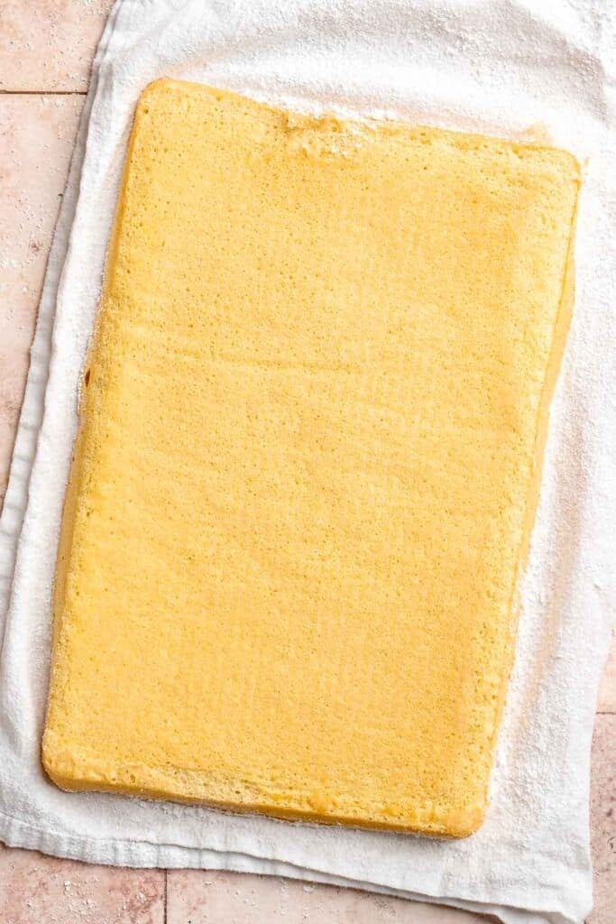 Light and fluffy vanilla Swiss roll cake filled with whipped cream, made with a soft sponge that rolls beautifully every time. | aheadofthyme.com