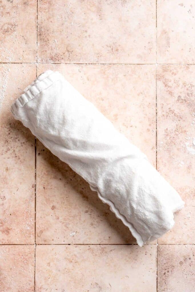 Light and fluffy vanilla Swiss roll cake filled with whipped cream, made with a soft sponge that rolls beautifully every time. | aheadofthyme.com