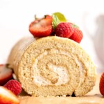 Light and fluffy vanilla Swiss roll cake filled with whipped cream, made with a soft sponge that rolls beautifully every time. | aheadofthyme.com