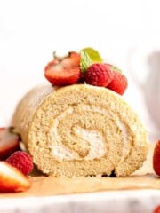 Light and fluffy vanilla Swiss roll cake filled with whipped cream, made with a soft sponge that rolls beautifully every time. | aheadofthyme.com