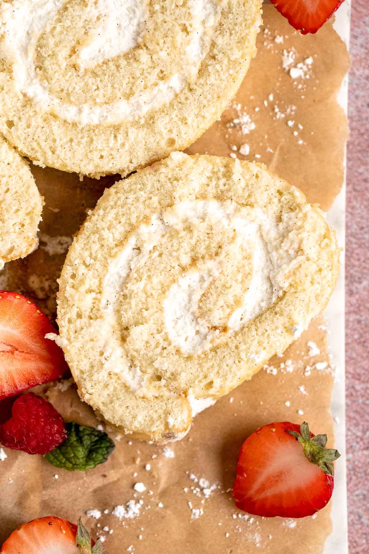 Light and fluffy vanilla Swiss roll cake filled with whipped cream, made with a soft sponge that rolls beautifully every time. | aheadofthyme.com