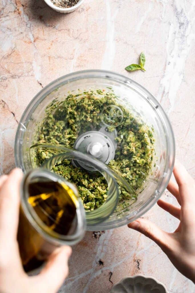 Fresh garlic scape pesto with basil, parmesan, toasted walnuts, and olive oil. Easy seasonal summer sauce for pasta, sandwiches, and more. | aheadofthyme.com