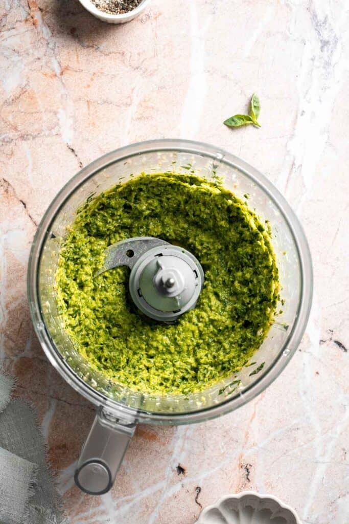 Fresh garlic scape pesto with basil, parmesan, toasted walnuts, and olive oil. Easy seasonal summer sauce for pasta, sandwiches, and more. | aheadofthyme.com