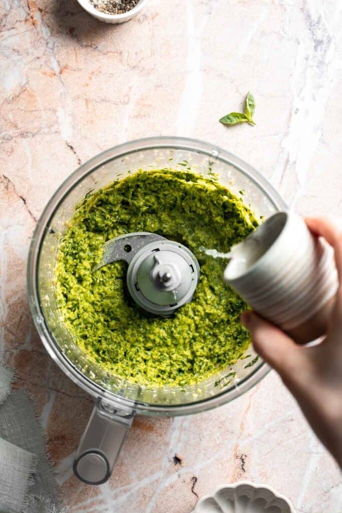 Fresh garlic scape pesto with basil, parmesan, toasted walnuts, and olive oil. Easy seasonal summer sauce for pasta, sandwiches, and more. | aheadofthyme.com
