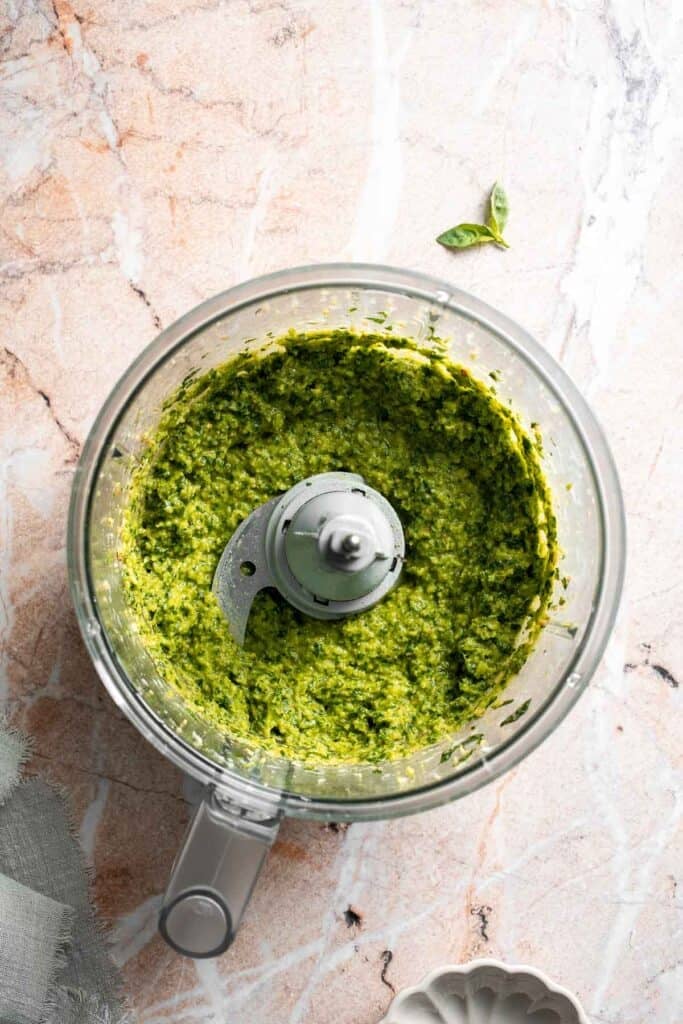 Fresh garlic scape pesto with basil, parmesan, toasted walnuts, and olive oil. Easy seasonal summer sauce for pasta, sandwiches, and more. | aheadofthyme.com