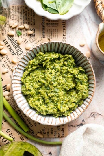 Fresh garlic scape pesto with basil, parmesan, toasted walnuts, and olive oil. Easy seasonal summer sauce for pasta, sandwiches, and more. | aheadofthyme.com