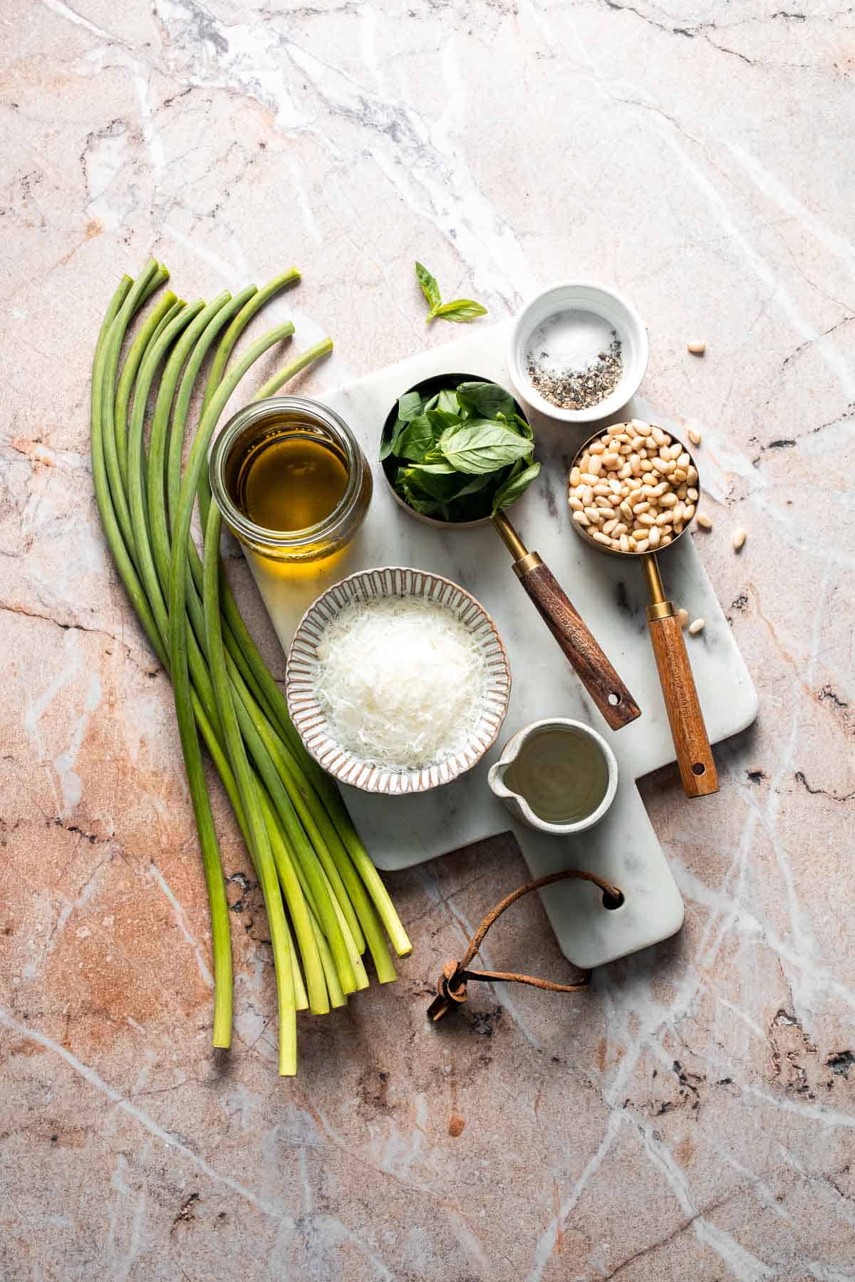 Fresh garlic scape pesto with basil, parmesan, toasted walnuts, and olive oil. Easy seasonal summer sauce for pasta, sandwiches, and more. | aheadofthyme.com