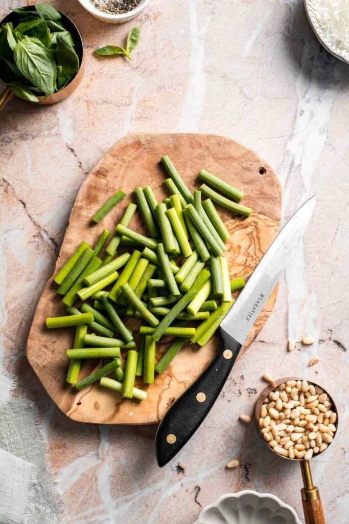 Fresh garlic scape pesto with basil, parmesan, toasted walnuts, and olive oil. Easy seasonal summer sauce for pasta, sandwiches, and more. | aheadofthyme.com