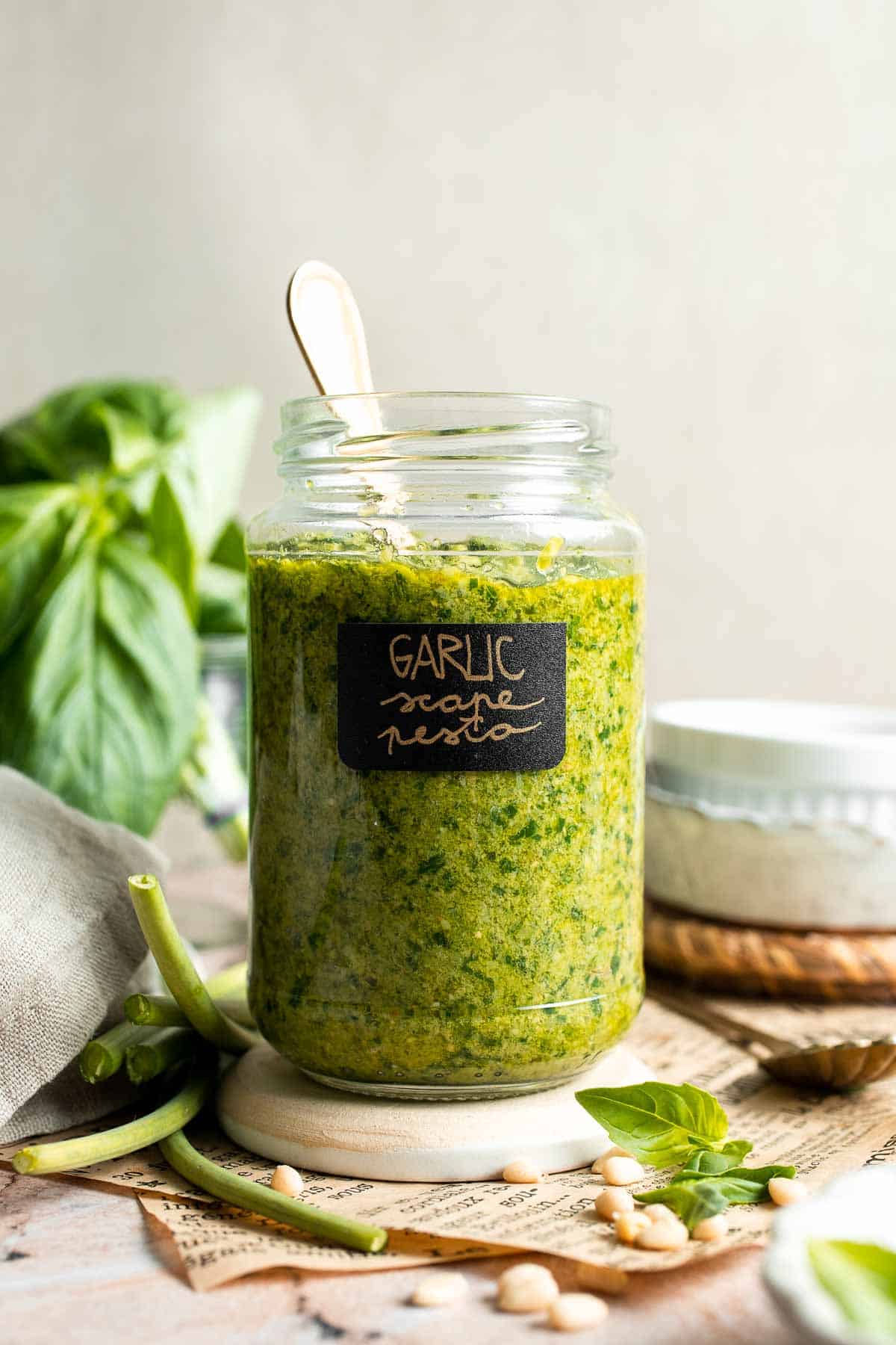Fresh garlic scape pesto with basil, parmesan, toasted walnuts, and olive oil. Easy seasonal summer sauce for pasta, sandwiches, and more. | aheadofthyme.com