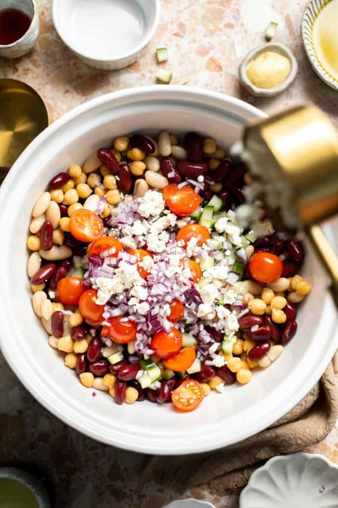 Mediterranean dense bean salad packed with chickpeas, vegetables, feta, and lemon dressing. Healthy meal prep salad full of fresh flavor. | aheadofthyme.com